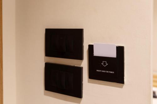 two boxes on a wall with a tv on it at La Boutique Hôtel - Vue Des Pyramides in Cairo