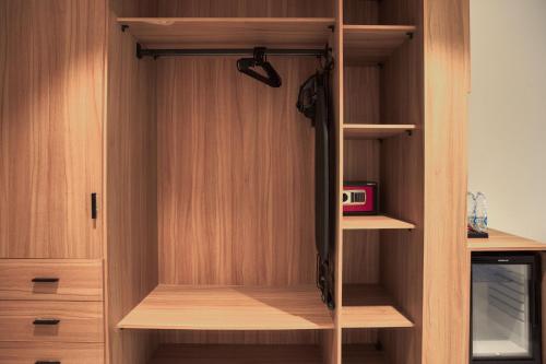 a closet with wooden walls and wooden shelves at La Boutique Hôtel - Vue Des Pyramides in Cairo