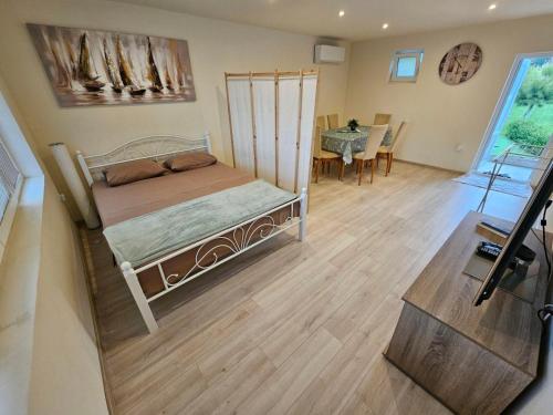 a bedroom with a bed and a dining room at Guest House 59 in Varna City