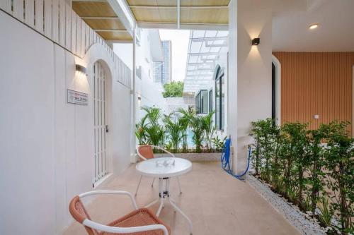 a hallway with a table and chairs in a building at Ayas Retreat - Muji Ekkamai Pool Villa with 4 bedrooms in Khlong Toei