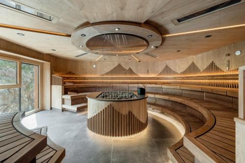 a wine tasting room with a stage and benches at Das Central – Alpine . Luxury . Life in Sölden