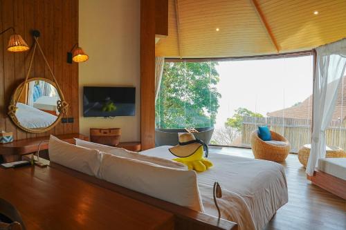 a bedroom with a large bed with a duck on it at Sinae Phuket - SHA Extra Plus in Phuket Town