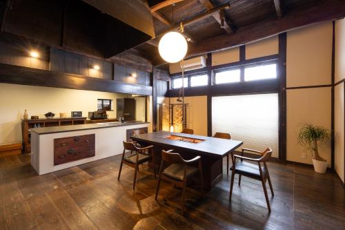 a kitchen with a dining room table and chairs at 雪の家 古澤邸 in Tokamachi