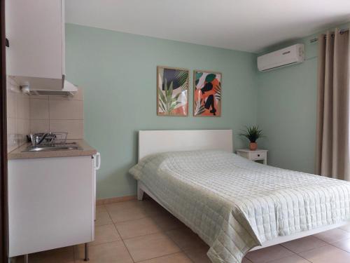 a small bedroom with a bed and a sink at Blue Sea Horizon in Iraklitsa