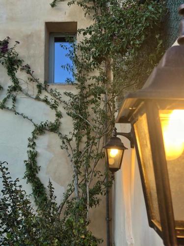 a street light next to a building with a window at Palazzo Contelori in Terni