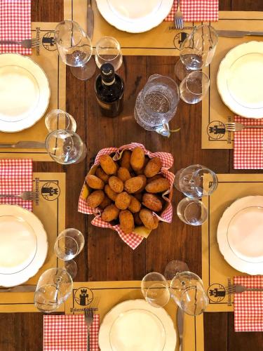 a table with plates and glasses and a bowl of food at Palazzo Contelori in Terni