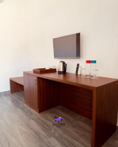 a wooden desk with a television on top of it at La Utopia Resort in Arambol