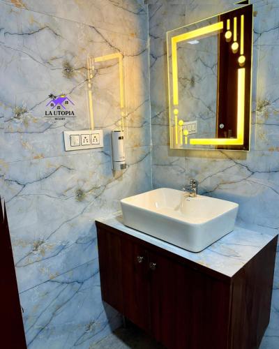 a bathroom with a white sink and a mirror at La Utopia Resort in Arambol