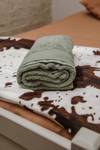 a towel is sitting on top of a table at Le Petit Guesthouse in Bloemfontein