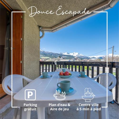 a table on the balcony of a house at Douce Escapade - Balcon - Parking in Jausiers