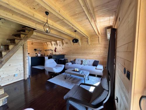 a living room with a couch and a table at Portes du Soleil - Zabljak in Žabljak