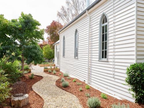 a side of a building with a gravel path next to it at The Old Trentham Church in Trentham