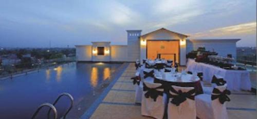 a restaurant with tables on the roof of a building at Best Western Plus Amritsar in Amritsar