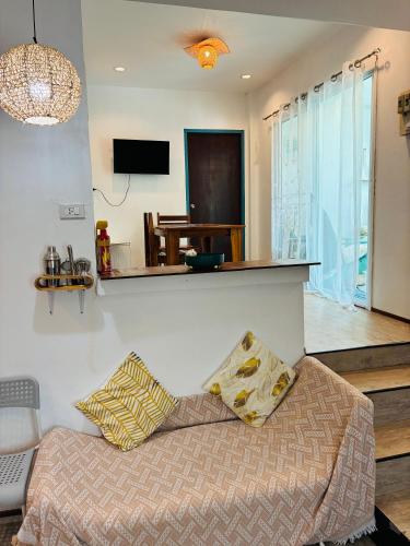 a living room with a bed and a tv at Dream Villa Beachfront Sunset in Ban Bang Po