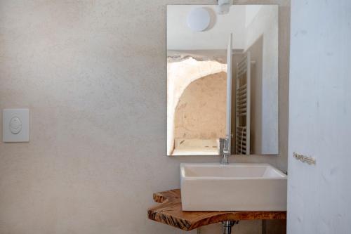 a bathroom with a sink and a mirror at Villa Stellina and Trullo Cecé in Ostuni
