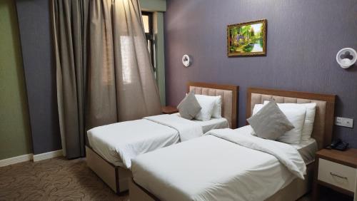 Ένα ή περισσότερα κρεβάτια σε δωμάτιο στο Royal Meridien Hotel
