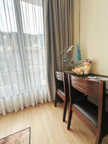 a dining room table with two chairs and a window at 260m walk to BTS Prakanong in Bangkok
