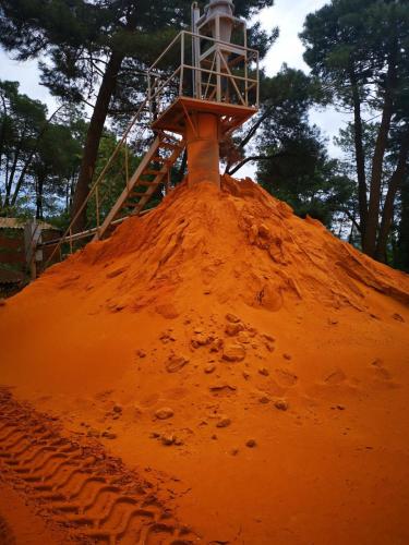 a mound of dirt with a lighthouse on top of it at Brin d'Olivier en Luberon in Gargas