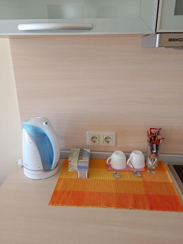 a kitchen counter with a blender and other items at Apart Hotel Golden Line private apartments in Golden Sands
