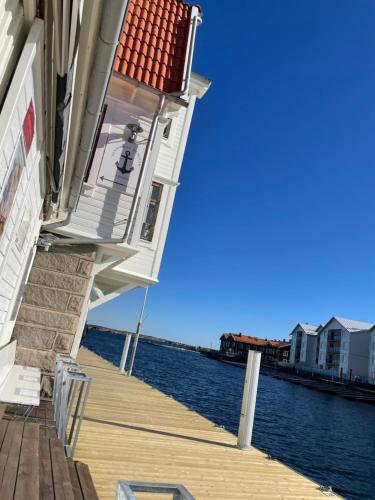 a building on a dock next to the water at Pensionat bryggan in Smögen