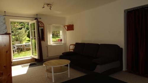 a living room with a couch and a table at Panda apartman in Esztergom