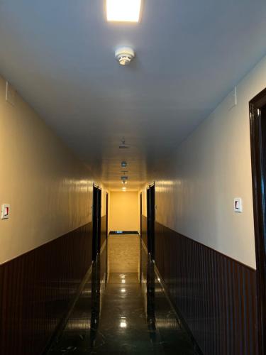 a long hallway with a light on the ceiling at Hotel Kavaka in Sambalpur