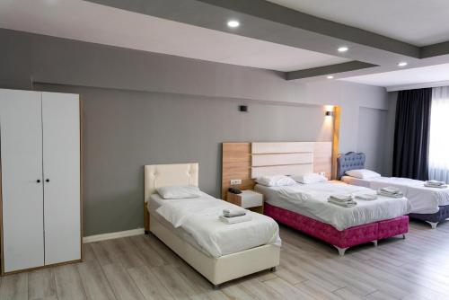 a hotel room with two beds at RİO's HOTEL KURTKÖY in Istanbul