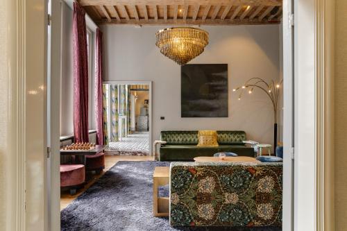 a living room with a couch and a table at Hotel De Witte Lelie -Small Luxury Hotels of the World in Antwerp