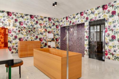 a room with floral wallpaper on the wall at Hotel De Witte Lelie -Small Luxury Hotels of the World in Antwerp