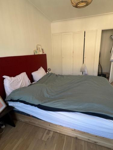 a bedroom with a large bed with a red headboard at Nice experience in Nice