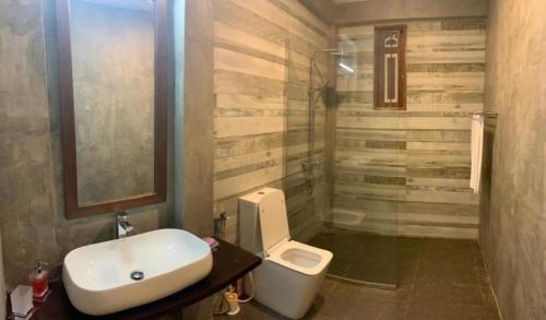 a bathroom with a sink and a toilet at Aanya Villa by the Beach in Mirissa