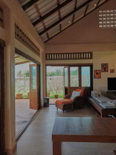 a living room with a couch and a table at Beach Front Villa, Saphli beach, Chumphon,Thailand in Ban Tha Samet (1)