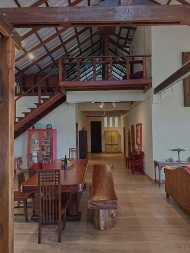 a room with a wooden table and chairs and a staircase at Beach Front Villa, Saphli beach, Chumphon,Thailand in Ban Tha Samet (1)