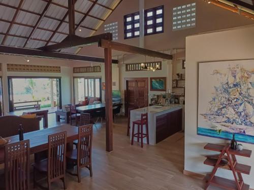 a kitchen and living room with a large painting on the wall at Beach Front Villa, Saphli beach, Chumphon,Thailand in Ban Tha Samet (1)