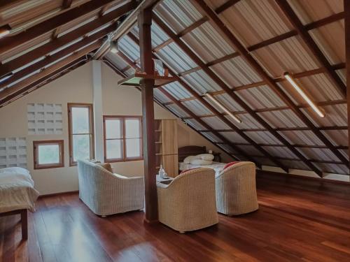 a attic room with a table and chairs in it at Beach Front Villa, Saphli beach, Chumphon,Thailand in Ban Tha Samet (1)