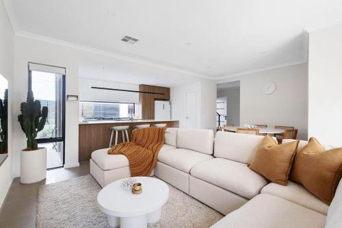 a living room with a couch and a table at Urban Haus - Hillarys in Perth