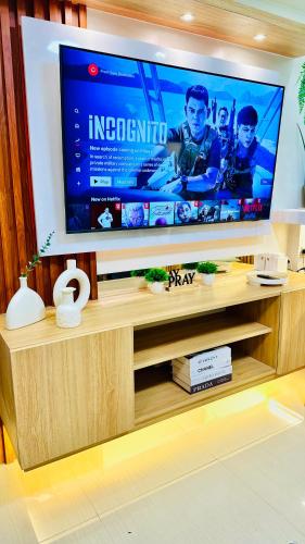 a large flat screen tv in a living room at MOA Newly Turn Over 1 bedroom with balcony PRIER Place in Manila