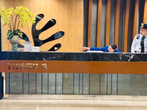 a police officer standing at a counter in a lobby at MOA Newly Turn Over 1 bedroom with balcony PRIER Place in Manila