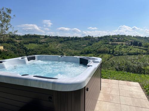 a jacuzzi tub sitting on top of a hill at Podere Baratta agriturismo e cantina in Collinello