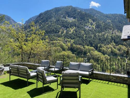 a group of chairs sitting on a balcony with a mountain at Quiet House Sa Calma in Andorra la Vella