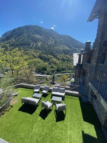 a group of chairs sitting on top of a lawn at Quiet House Sa Calma in Andorra la Vella