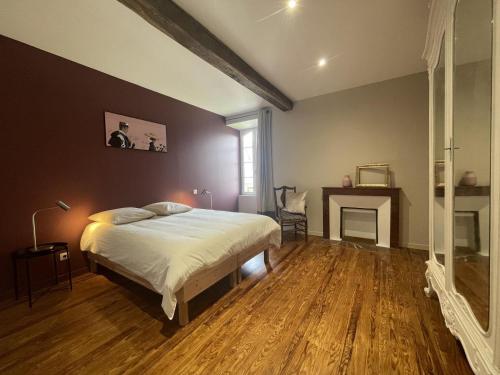 a bedroom with a large bed and a fireplace at Prat in Livron