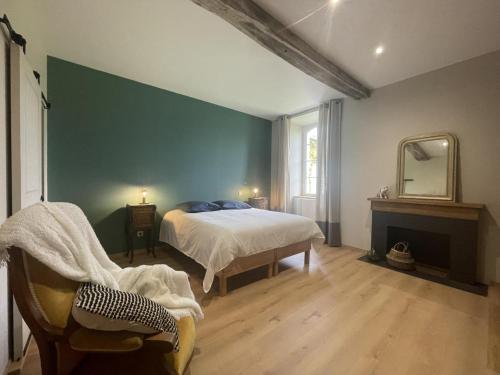 a bedroom with a bed and a mirror and a chair at Prat in Livron