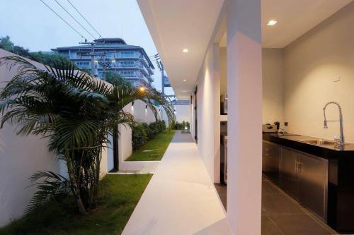 a hallway of a house with a palm tree at Pattaya Near Beach & Walk Street Luxury Villa in Pattaya South