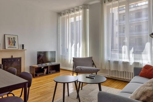 un salon avec un canapé, des chaises et une télévision dans l'établissement Le Lili's Home élégant F4 proche du centre-ville de Rouen, à Rouen