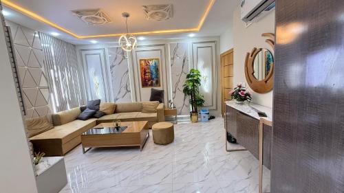 a living room with a couch and a table at ParkView City Lake Facing in Malot