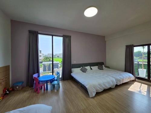 a bedroom with a large bed and a large window at Six Children in Gongguan