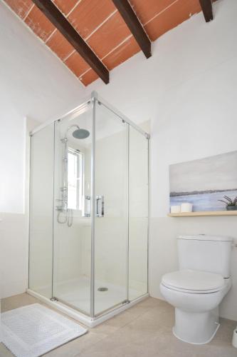 a glass shower in a bathroom with a toilet at Rufo - Casablanca House in Alcudia