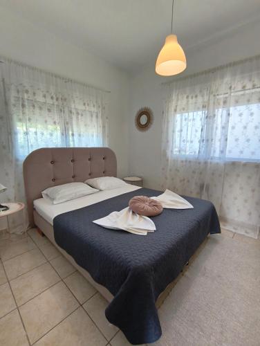 a bedroom with a large bed with towels on it at Cozy apartment in Ialysos