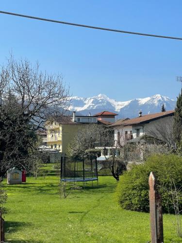 a park with a bench and mountains in the background at La Dimora di Borgo in Borgo San Dalmazzo